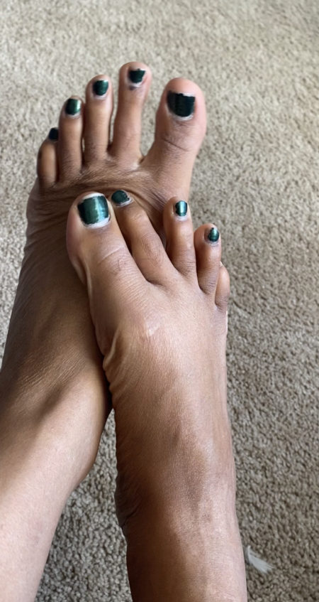 Brown feet w/green toes. Mama needs a pedi